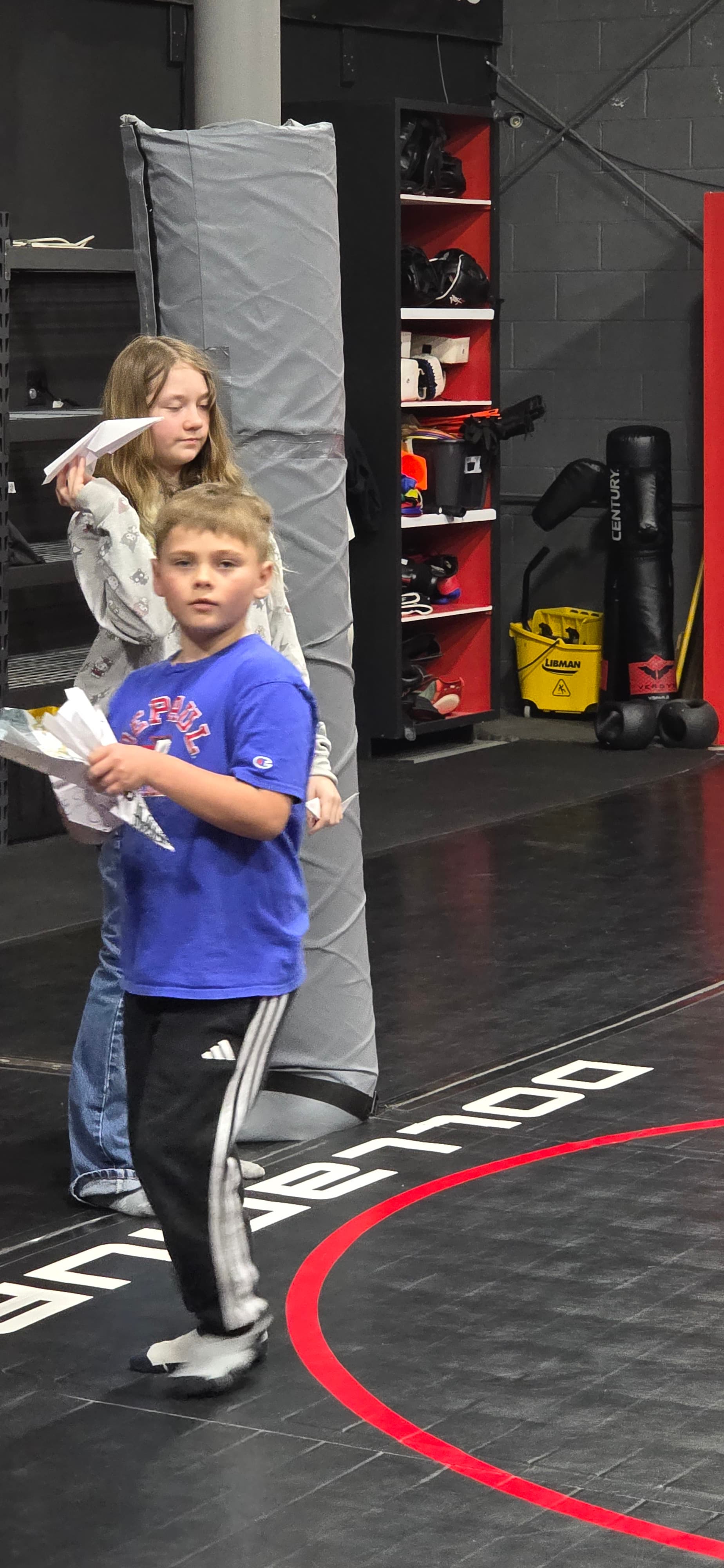 Child showing a handmade paper craft in the activity room