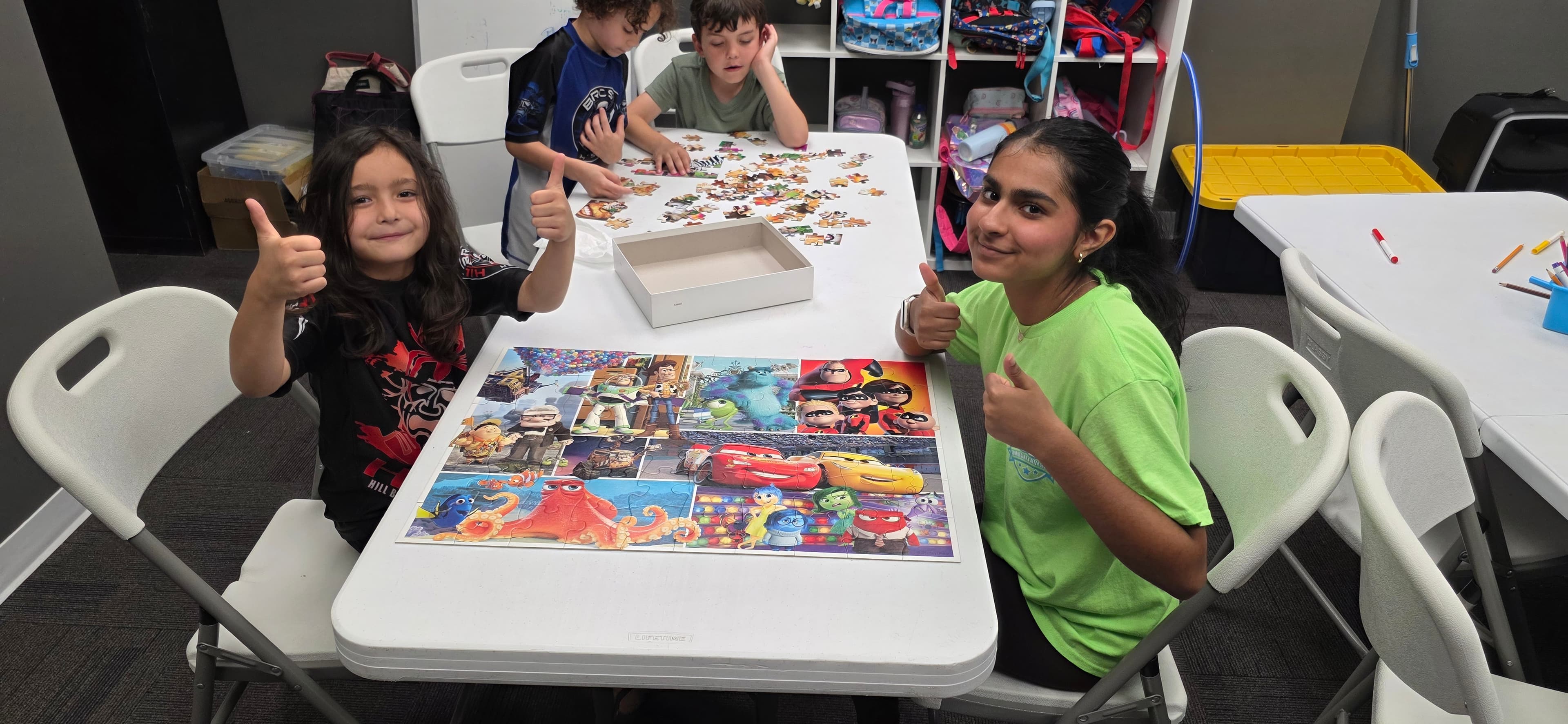 Children working together on a puzzle in the activity room